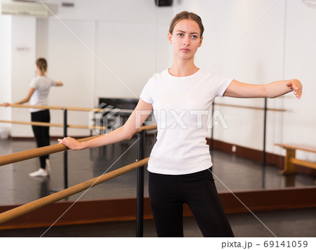 Woman warming up in dance hall Woman warming up in dance hall 69141059