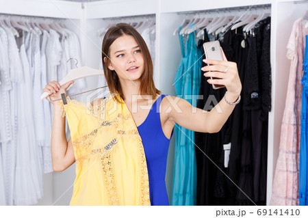 Girl taking selfie with new dress Girl taking selfie with new dress 69141410
