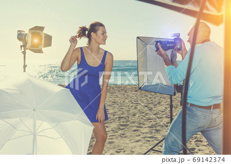 Photo shoot of smiling model with photographer Photo shoot of smiling model with photographer 69142374