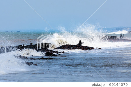 Large ocean waves crashing and hitting on mediterranean sea beach water surface.  69144079