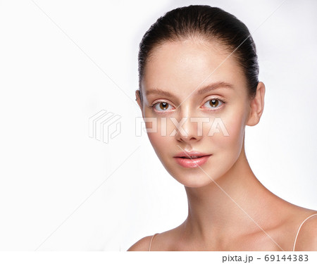 Beautiful young girl with a light natural make-up and perfect skin. Beauty face. Beautiful young girl with a light natural make-up and perfect skin. Beauty face. 69144383
