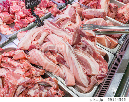 Pile of raw pork chop meat at butchers shop Pile of raw pork chop meat at butchers shop 69144546