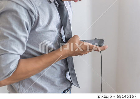 Man in shirt text message on phone Man in shirt text message on phone 69145167