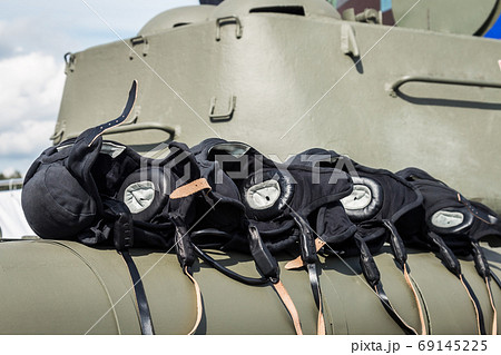 military helmets of the tank crew lie on the tank's armor 69145225