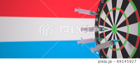 Vaccine syringes with text and flag of Luxembourg as a background. Luxembourgian Medical research and vaccination, 3D rendering 69145927