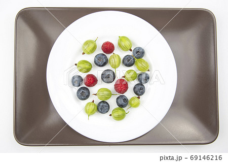 Assorted fresh different berries on a white plate. useful vitami 69146216