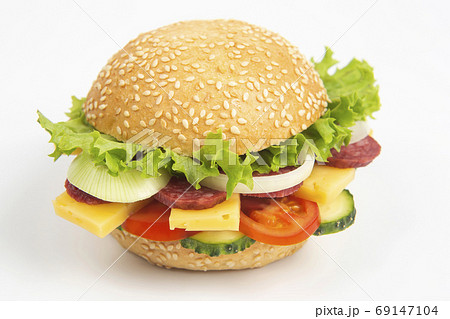Hamburger with vegetables and sausage on a white background. Fas Hamburger with vegetables and sausage on a white background. Fas 69147104