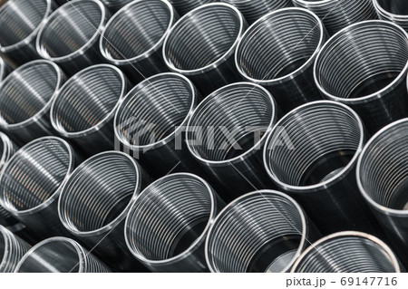 Billet obtained on lathe from steel. Many of same parts on pallets in industrial factory. Expect further processing. Metal industry products, workpieces. Steel products to automotive industry. 69147716