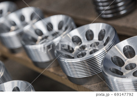 Cylindrical steel metal part with round holes made on lathe. Metal industry products, workpieces. Steel products to automotive industry. Billet obtained on lathe from steel and cast iron Cylindrical steel metal part with round holes made on lathe. Metal industry products, workpieces. Steel products to automotive industry. Billet obtained on lathe from steel and cast iron 69147792
