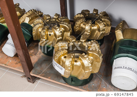 Oil equipment for drilling rig operation on oil platform in oil and gas industry. Brand new PDC Polycrystalline Diamond Compact drilling head for core drilling. Written: drilling bit and marking Oil equipment for drilling rig operation on oil platform in oil and gas industry. Brand new PDC Polycrystalline Diamond Compact drilling head for core drilling. Written: drilling bit and marking 69147845