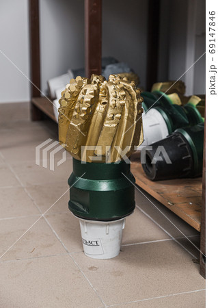 Drill Bit in factory stock. Oil drilling equipment for drilling rig operation on oil platform in oil and gas industry. Brand new PDC Polycrystalline Diamond Compact drilling bit 69147846