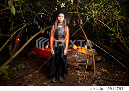 Girl in witch costume at party Girl in witch costume at party 69147934