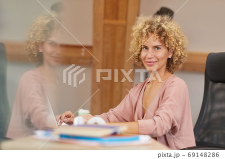 Businesswoman working on laptop Businesswoman working on laptop 69148286
