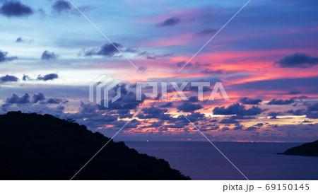 Majestic clouds in the sky sunset or sunrise over sea. 69150145