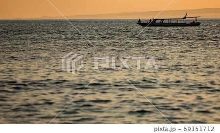 small boat floats on the water against the background of mountains small boat floats on the water against the background of mountains 69151712