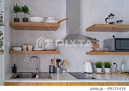 Modern kitchen interior with white brick tile wall in Scandinavian style Modern kitchen interior with white brick tile wall in Scandinavian style 69153436