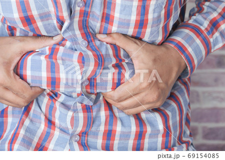 man's hand holding excessive belly fat, overweight concept man's hand holding excessive belly fat, overweight concept 69154085