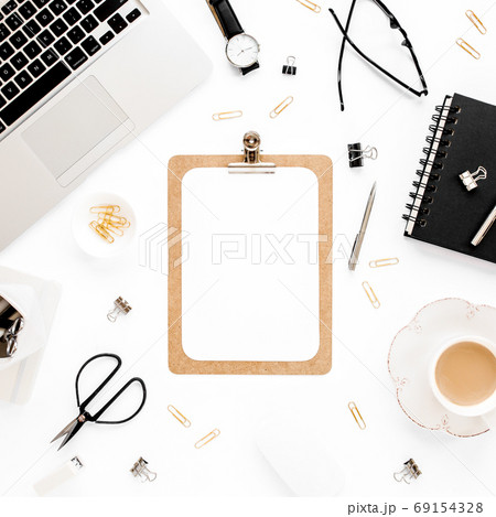 Home office workspace mockup with laptop, clipboard, notebook and accessories on white background. Flat lay, top view 69154328