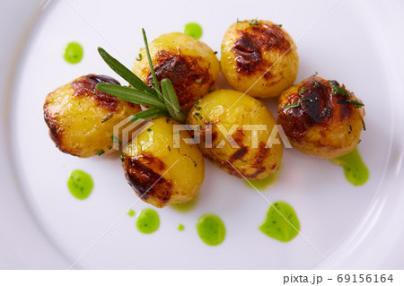 Vegan cuisine. Grilled baby potatoes with rosemary. Shallow dof. 69156164