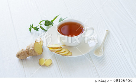 Healthy ayurvedic tea with ginger and mint leaves Healthy ayurvedic tea with ginger and mint leaves 69156456