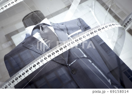 Mannequin in a mens suit surrounded by a tailors tape measure Mannequin in a mens suit surrounded by a tailors tape measure 69158014