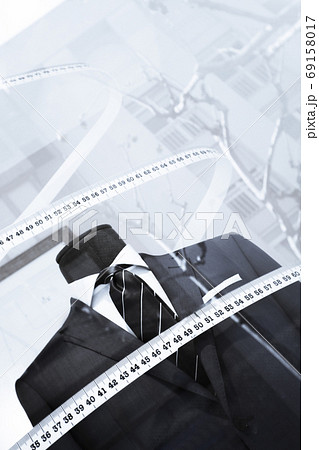 Mannequin in a mens suit surrounded by a tailors tape measure Mannequin in a mens suit surrounded by a tailors tape measure 69158017
