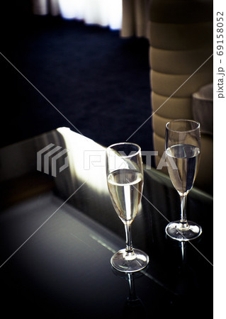 Two glasses of water on a glass table 69158052