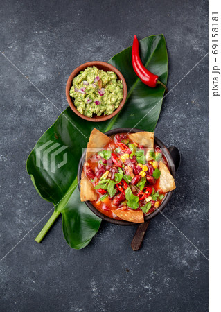 Mexican black bean soup with homemade fried tortillas totopos nachos served with guacamole 69158181