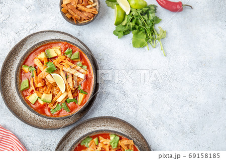 Aztec soup. Mexican sopa azteca with fried tortilla . Top view 69158185