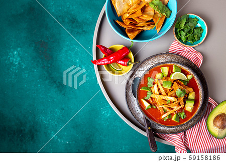 Mexican style table with spicy aztec soup with tortilla. Copy space 69158186