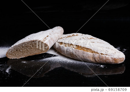 Gray bread sprinkled with flour. Homemade pastries, bread cut gavpil Gray bread sprinkled with flour. Homemade pastries, bread cut gavpil 69158709
