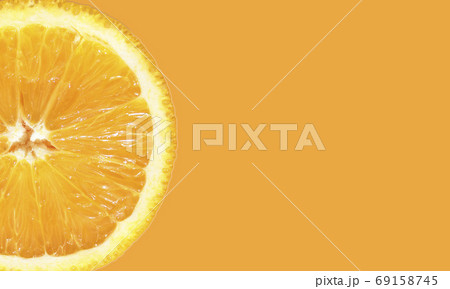 Orange slice on an orange background with space for text. Advertising. Banner. Poster. Orange slice on an orange background with space for text. Advertising. Banner. Poster. 69158745