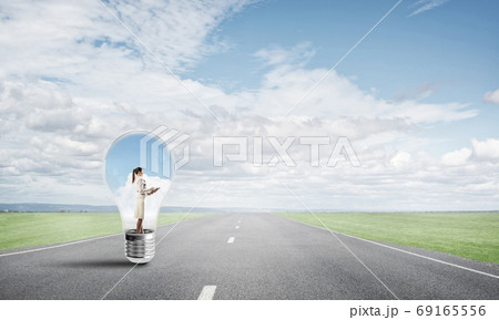 Businesswoman inside light bulb 69165556