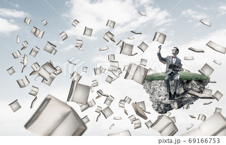 Young businessman or student studying the science and books fly around 69166753