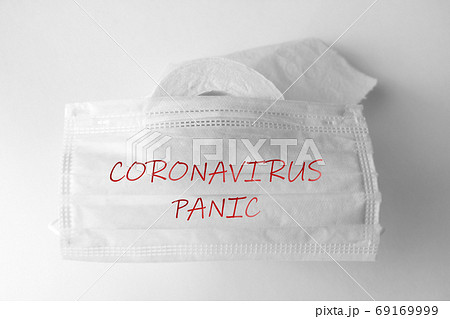 Toilet roll and medical mask on background with text. Concept of lack of toilet paper in stores due to coronavirus, covid-19, hygiene, panic. 69169999