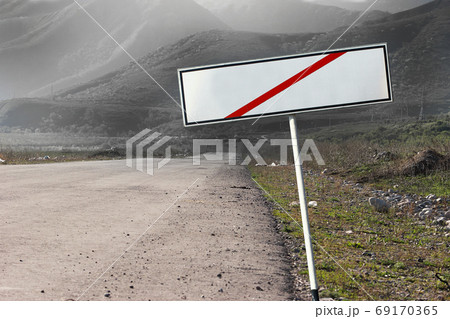 Empty crossed out blank road sign concept. The path extending into a gloomy distance Empty crossed out blank road sign concept. The path extending into a gloomy distance 69170365