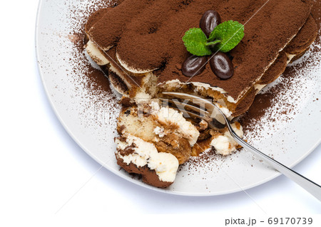 portion of Classic tiramisu dessert on ceramic plate isolated on white background with clipping path 69170739