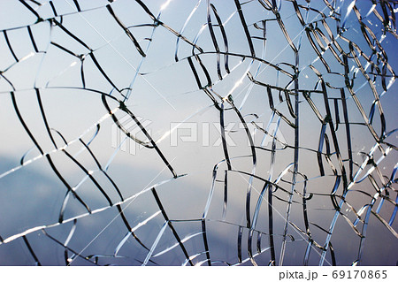 Close up view on a cracked glass background Close up view on a cracked glass background 69170865