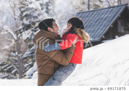 Asian father and son playing in the park on winter day Asian father and son playing in the park on winter day 69171870