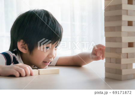 Cute Asian child playing wood blocks stack game 69171872