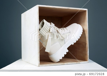 white boots in wooden box. fashion shoes still life 69172028