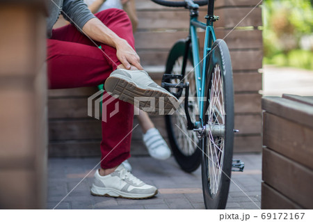 Young man in red pants next to the track bike Young man in red pants next to the track bike 69172167