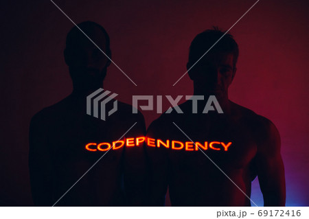 Man couple standing together with Codependency word oh his body Man couple standing together with Codependency word oh his body 69172416