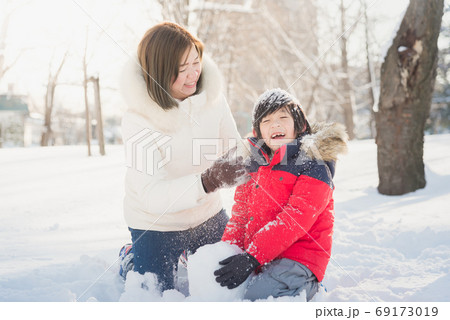 Asian mother and son enjoying snowy winter Asian mother and son enjoying snowy winter 69173019