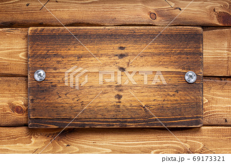aged wooden nameplate at wood board background 69173321