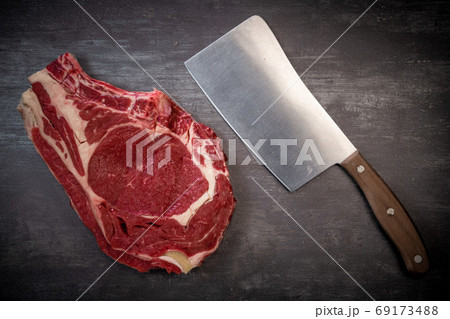 Raw T Bone steak on wooden board prepared to Grill Raw T Bone steak on wooden board prepared to Grill 69173488