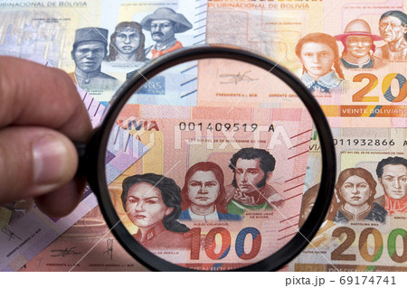 Bolivian money in a magnifying glass  69174741