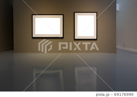 Blank photo frame on golden wall in art gallery. 69176990