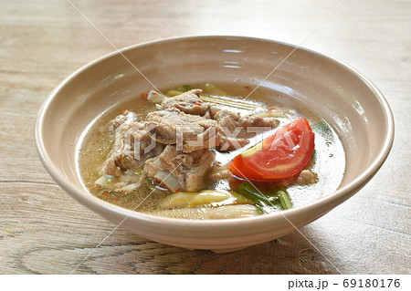 hot and spicy pork bone with mushroom in Thai tom yum soup on bowl hot and spicy pork bone with mushroom in Thai tom yum soup on bowl 69180176