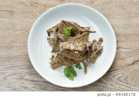 fried slice pork liver with garlic and pepper topping parsley on plate 69180178
